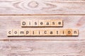 Disease complication word written on wood block. disease complication text on wooden table for your desing, coronavirus concept