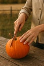 Hands cutting a pumpking on wooden table Royalty Free Stock Photo