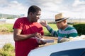 Disgruntled african american farmer reprimanding hispanic contractor