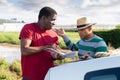 Disgruntled african american farmer reprimanding hispanic contractor