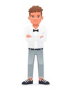 A disgruntled little boy stands with his arms crossed. A beautiful cute schoolboy child in a white shirt with a bow tie