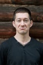 Disgruntled man on wooden background. Village Royalty Free Stock Photo