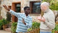 Disgruntled men talking in backyard Royalty Free Stock Photo