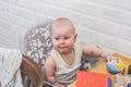 Disgruntled upset baby girl sitting at the dinner table Royalty Free Stock Photo