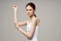 Disgruntled woman elbow pain massage health studio