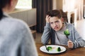 Disgust, food and child with vegetables in home for nutrition, health and cooking. Lunch, angry and dinner with boy and Royalty Free Stock Photo