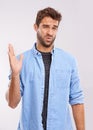 Disgust, man and waving his hands for smell, unpleasant and bad stink on a grey studio background. Face, person and Royalty Free Stock Photo