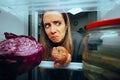 Woman Taking out a Rotten Fruit from her Fridge Royalty Free Stock Photo