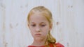 Disgusted girl looking with disgust on light background in studio. Portrait squeamish girl teenager wincing face close