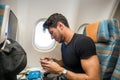 Disgusted man tasting insipid food in plane