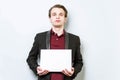 Disgusted, not happy young business man in red polo shirt and blazer holding blank A4 sheet of paper for slogan. Lose a job Royalty Free Stock Photo