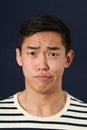 Disgusted young Asian man looking at camera Royalty Free Stock Photo