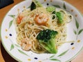 A dish of aglio olio shrimp and broccoli pasta