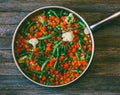 Dish Asian Cuisine. Vegetable Mixture Of Carrots, Peas, Green Beans And Cauliflower In A Frying Pan