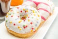 Dish with assorted donuts, coffee and juice Royalty Free Stock Photo