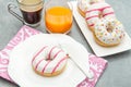 Dish with assorted donuts, coffee and juice Royalty Free Stock Photo