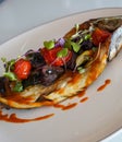 Dish of baked bream with vegetables in a gourmet restaurant