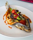 Dish of baked bream with vegetables in a gourmet restaurant