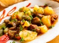 Dish of baked potatoes with beef stew with herbs Royalty Free Stock Photo