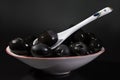 Dish of black olives close up against a dark background Royalty Free Stock Photo
