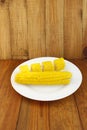 Dish with boiled corns on the wooden background Royalty Free Stock Photo