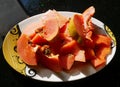 A dish of bright orange slices of papaya Royalty Free Stock Photo