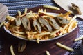 Dish of CHEESY SEEKH FRIES at cafe restaurant. American fast food dish, consisting of french fries covered in cheese