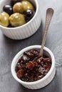 A dish of chutney and a dish of black and green olives Royalty Free Stock Photo