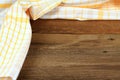 Dish cloth in yellow and white on brown wooden table Royalty Free Stock Photo