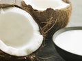 Dish of Coconut Milk with a Split Fresh Coconut Royalty Free Stock Photo