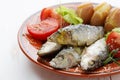 Dish of cooked sardines with salt