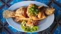 A dish of crispy Thai style deep fried whole sea bass fish served Royalty Free Stock Photo