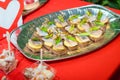 Dish of delicious canapes with herring and green onion on slices of boiled potatoes and black bread. traditional Russian appetiz