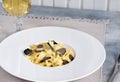 Dish of delicious italian pasta tagliatelle with truffle mushroom chips Royalty Free Stock Photo