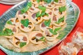 Dish of delicious tartlets with seafood in cream sauce and parsley