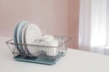 Dish drainer with clean dinnerware Royalty Free Stock Photo