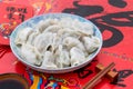 A dish of dumplings under the background of red couplets during the Spring Festival