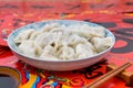 A dish of dumplings under the background of red couplets during the Spring Festival