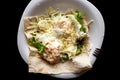 A dish of eggs. Fried eggs with pita bread, lettuce and cheese on a white and black plate Royalty Free Stock Photo