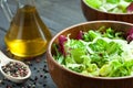 A dish of fresh salad frisse, Romano and radiccio with olive oil, salt and freshly ground percec in a wooden bowl Royalty Free Stock Photo