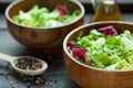 A dish of fresh salad frisse, Romano and radiccio with olive oil, salt and freshly ground percec in a wooden bowl Royalty Free Stock Photo