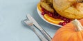 A dish of fried chicken, pumpkin and cutlery lies on the table. View from above. Copy space for text. Can be used as a layout for