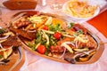 A dish of fried meat, vegetables, French fries, tomatoes Royalty Free Stock Photo