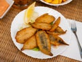 Dish with fried sardines, pilchards or anchovies in batter for traditional Spanish meal Royalty Free Stock Photo