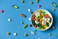 A dish full of pills, tablets, vitamins, drugs, omega 3 fish oil, gel capsules, medicament and food supplement for health care. Royalty Free Stock Photo
