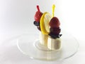 Dish for gourmet. Healthy food. Vegetarian foods on a transparent plate. Berries and fruits. Lemon and cherry for a snack. Photo
