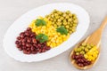 Dish with green peas, beans, sweet corn, parsley and spoon Royalty Free Stock Photo