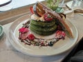 A dish of green tea pancake with a variety of fruits