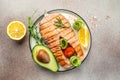 Dish grilled salmon steak with avocado and fresh vegetable salad. Keto diet concept healthy food, Healthy fats, clean Royalty Free Stock Photo