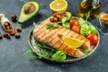 Dish grilled salmon steak with avocado and fresh vegetable salad. Keto diet concept healthy food, Healthy fats, clean Royalty Free Stock Photo